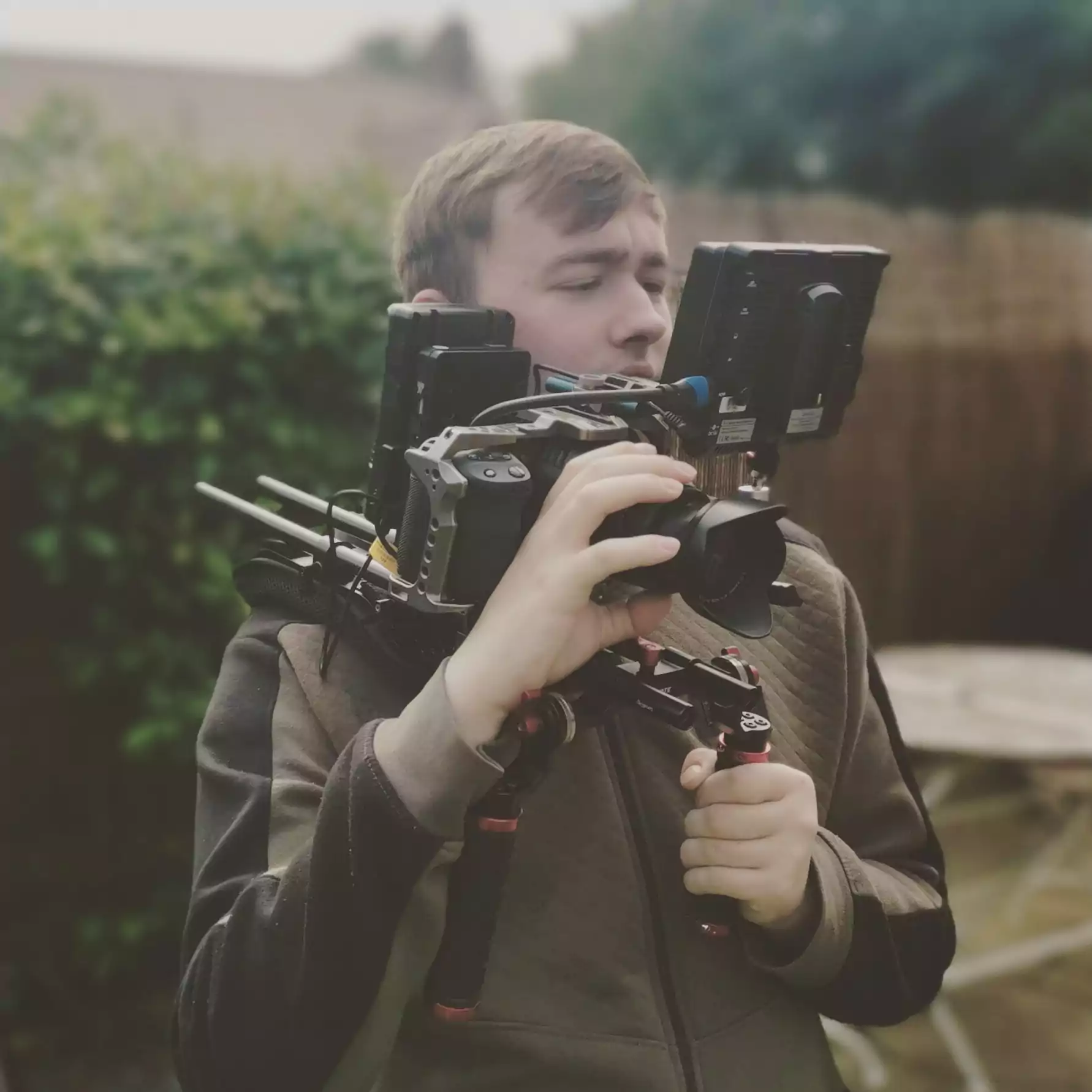 Joshua Belcher holding a professional cinematography camera